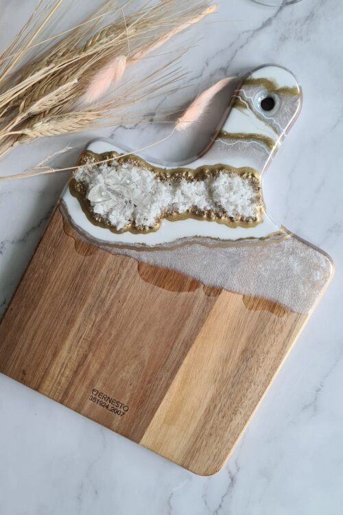 Wooden cheese board with white, gold and silver resin.
