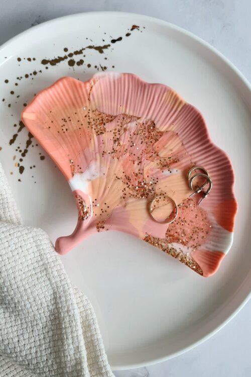 Ginkgo biloba leaf shaped trinket tray made of pink, orange, white resin with gold glitter