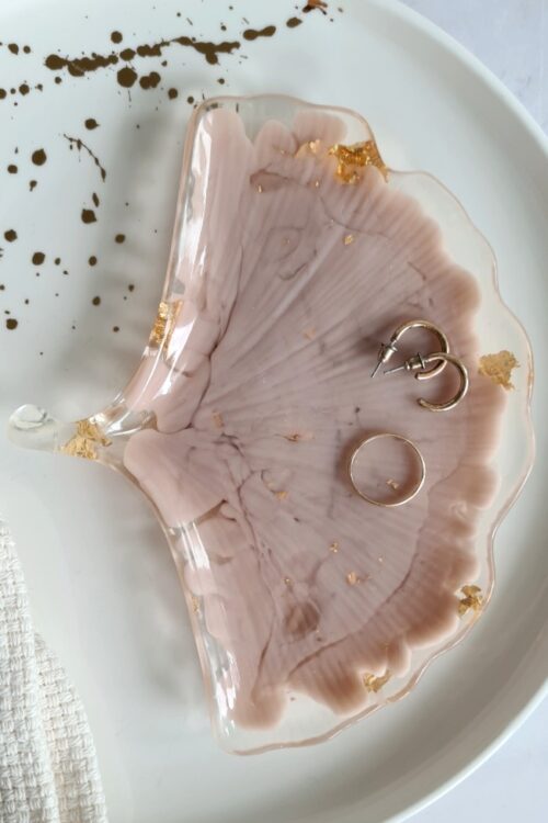 Ginkgo biloba leaf shaped trinket tray made of transparant and beige resin with golden flakes in it