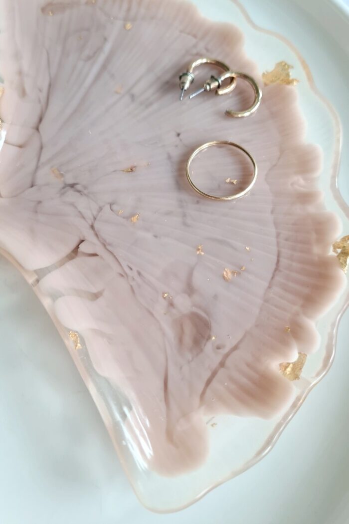 Ginkgo biloba leaf shaped trinket tray made of transparant and beige resin with golden flakes in it