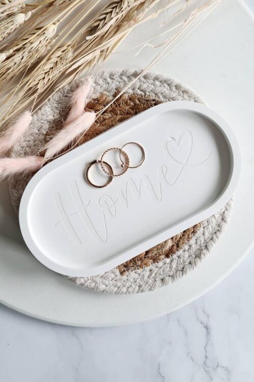 Oval jewerly dish made with white Jesmonite with the text home