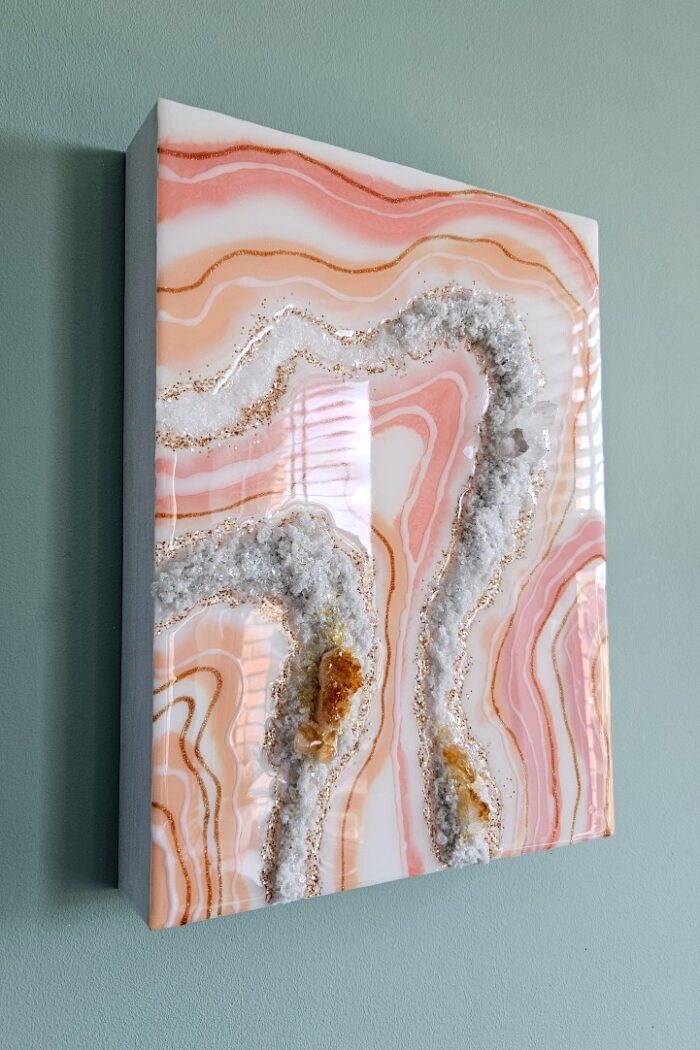 Handmade pink and orange resin wall art with rock crystal and citrine crystal.