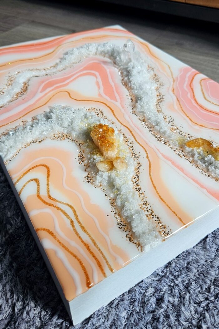 Handmade pink and orange resin wall art with rock crystal and citrine crystal.