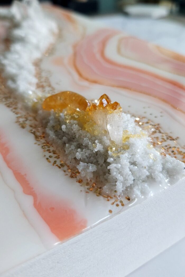 Handmade pink and orange resin wall art with rock crystal and citrine crystal.