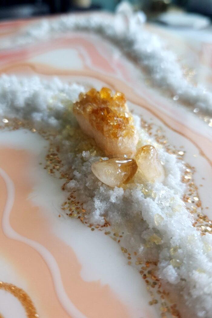 Handmade pink and orange resin wall art with rock crystal and citrine crystal.
