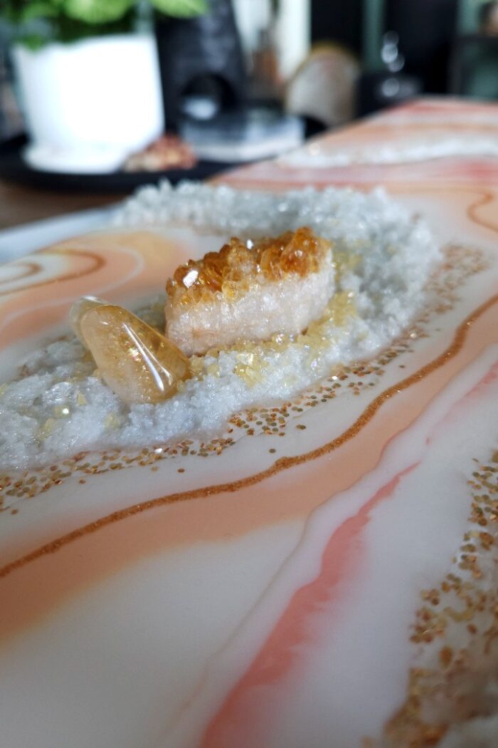 Handmade pink and orange resin wall art with rock crystal and citrine crystal.